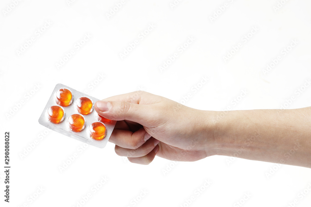 hand man holding color pills in blister pack on white background, close up