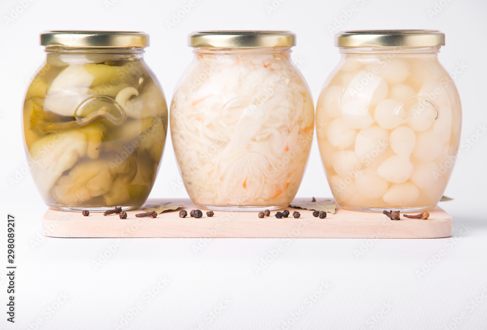 Pickled peppers, onions and cabbage on a white plate in a jar Pickled peppers, onions and cabbage on a white plate in a jar