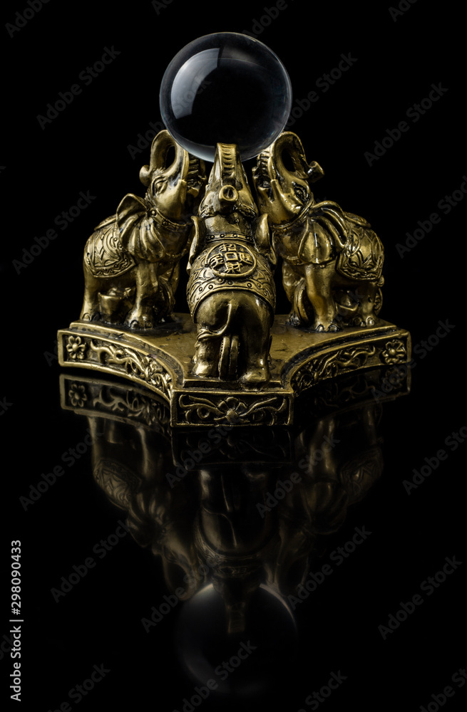Figurine in the form of tree elephants that hold a glass ball Figurine in the form of tree elephants that hold a glass ball