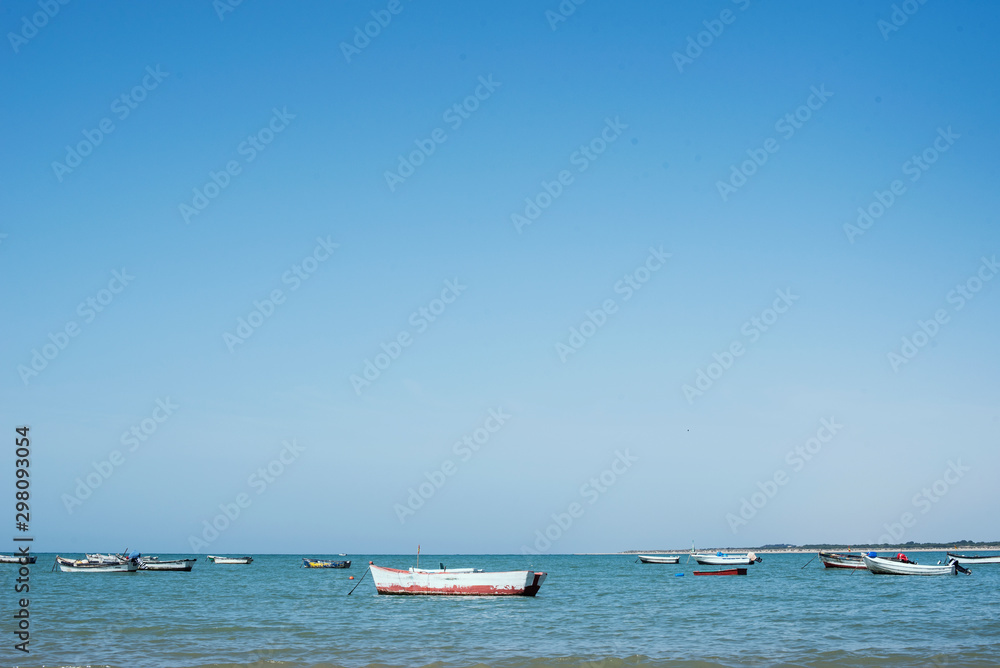 Little boats on the sea. Daylight and blue water.