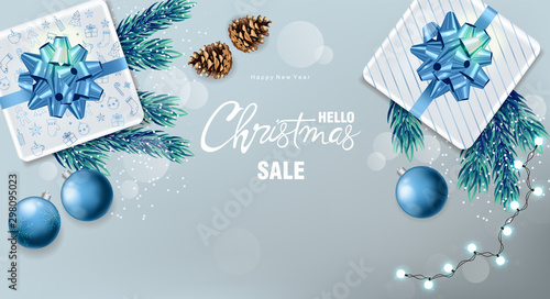 Christmas sale panoramic banner with wrapped gift boxes, pine tree leaves, ba...