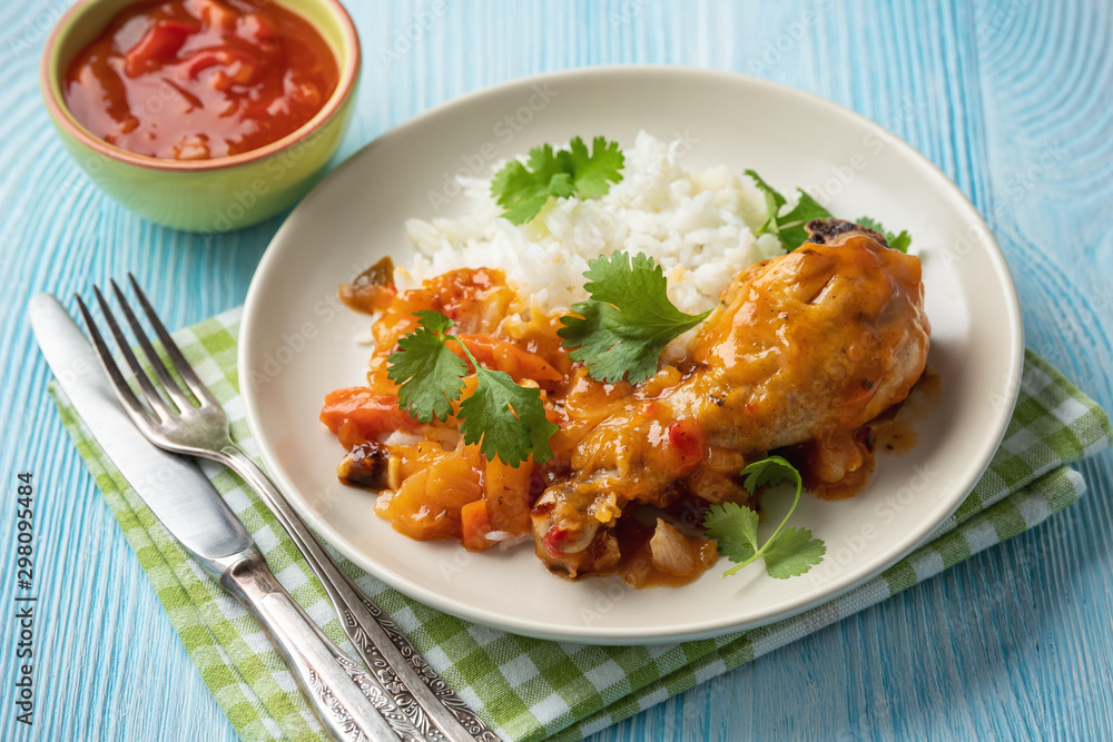 Chicken drumstick in tomato sauce with boiled rice. Chicken drumstick in tomato sauce with boiled rice.