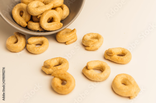Taralli is a traditional Italian appetizer, similar to drying or bagels, typical of the cuisine of Sicily and Calabria. Bagel on a white background in a bowl.