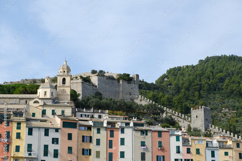 Panorama of Portovenere near the Cinque Terre with typical colorful houses. The church, the casttle with  towers and walls..