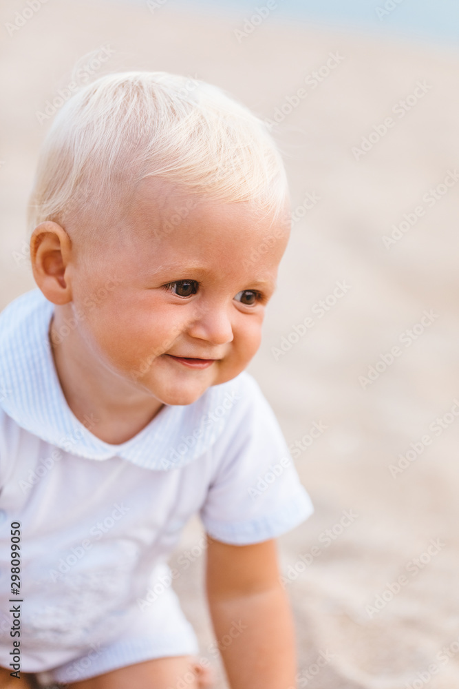 Portrait of a blonde baby smiling on the beach Portrait of a blonde baby smiling on the beach