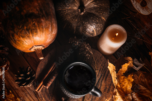 Autumn still life, pumpkins, light bulb and dry leaves on rustic background