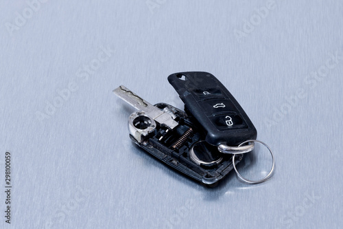 Broken or damaged car key fob on aluminium background. Repair of broken or damaged remote key fob of any vehicle car service.- Image photo