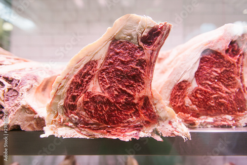 Raw beef steak on a chiller at a butcher's shop for maturing photo