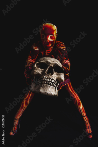 sensual woman dressed in a skeleton costume sitting on floor