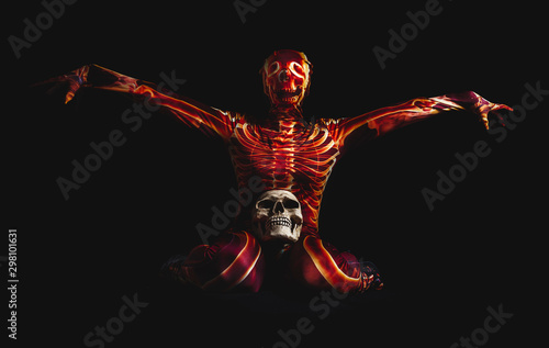 sensual woman dressed in a skeleton costume sitting on floor