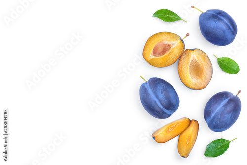 fresh blue plum and half with leaves isolated on white background with copy space for your text. Top view. Flat lay
