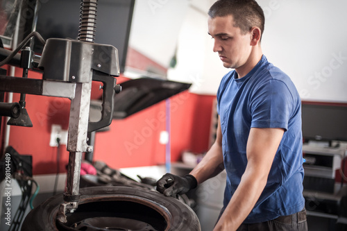 Car master mechanic vulcanizer repairing tire on auto vulcanizing machine