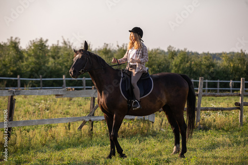Young girl with her horse in evening sunset light