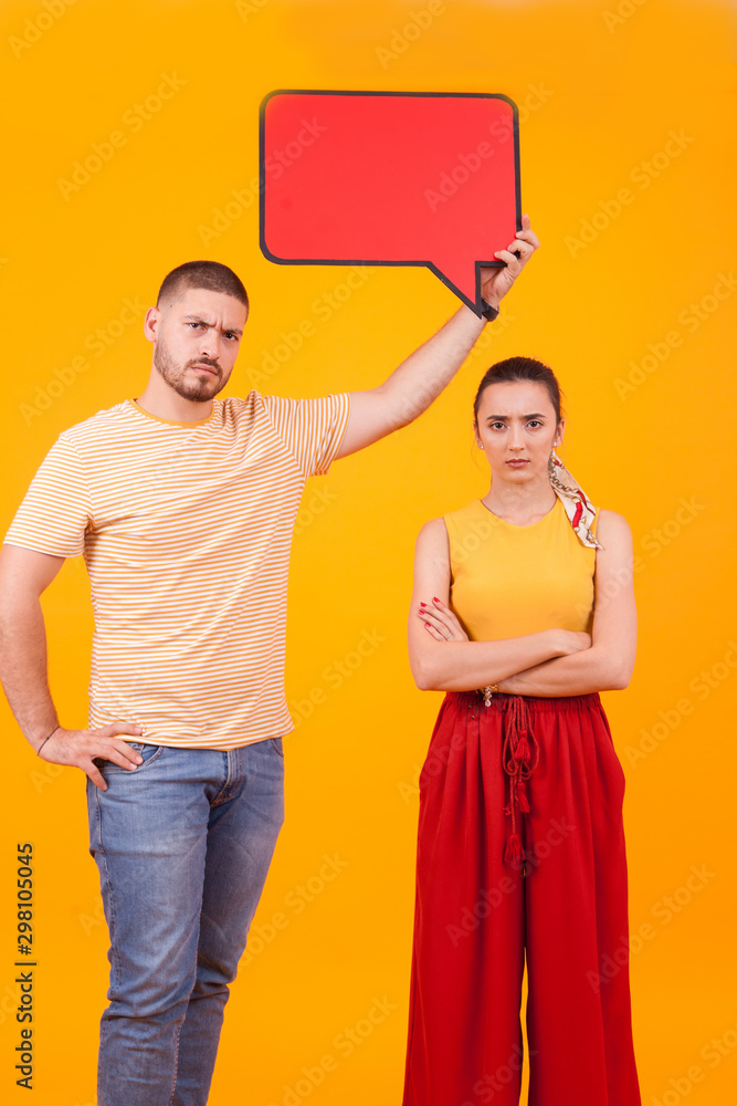 Fototapeta premium Couple with angry facial expression holding empty bubble thought