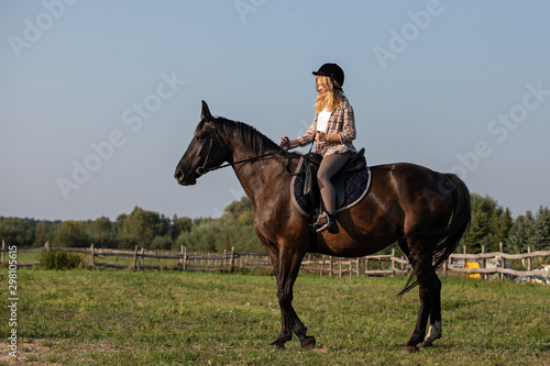 Young girl with her horse in evening sunset light