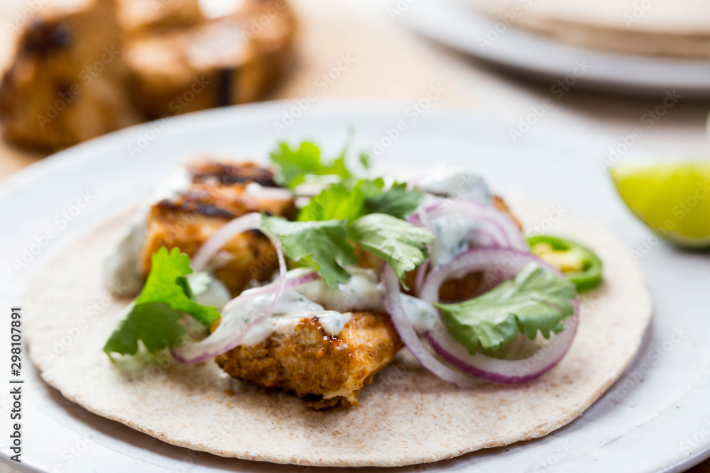 Chicken tikka wraps with Indian spices and condiments Chicken tikka wraps with Indian spices and condiments