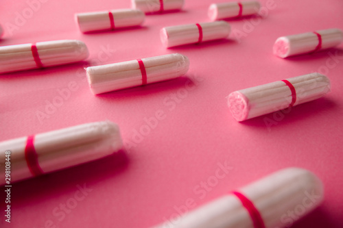 Tampons on pink background. Feminine hygiene. Flat lay