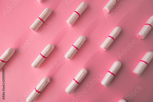 Tampons on pink background. Feminine hygiene. Flat lay