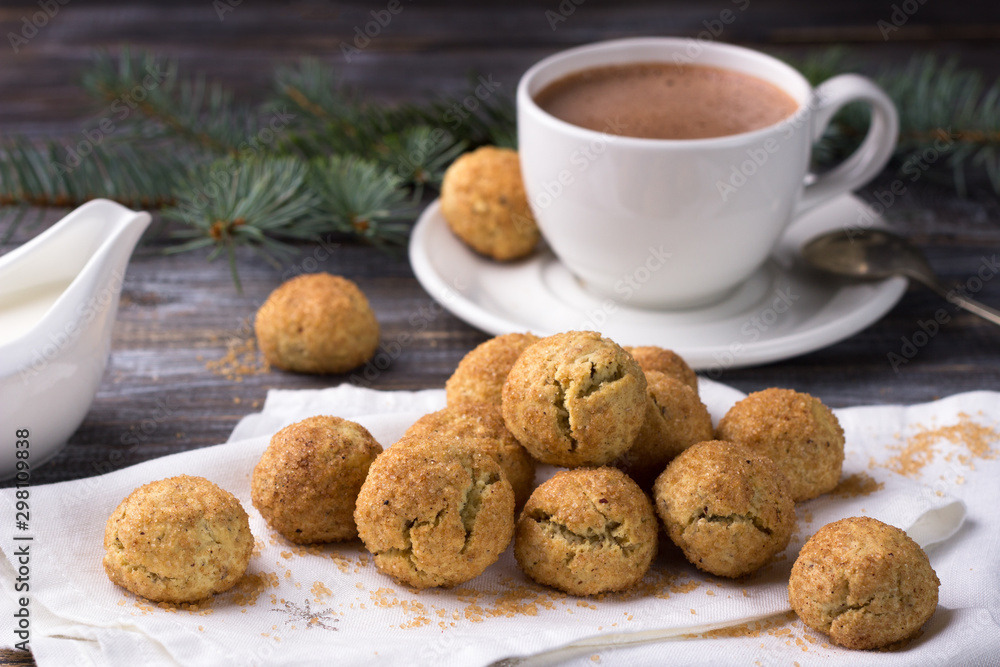 Freshly baked snickerdoodle cookies with cinnamon and nuts, hot chocolate on wooden background Freshly baked snickerdoodle cookies with cinnamon and nuts, hot chocolate on wooden background