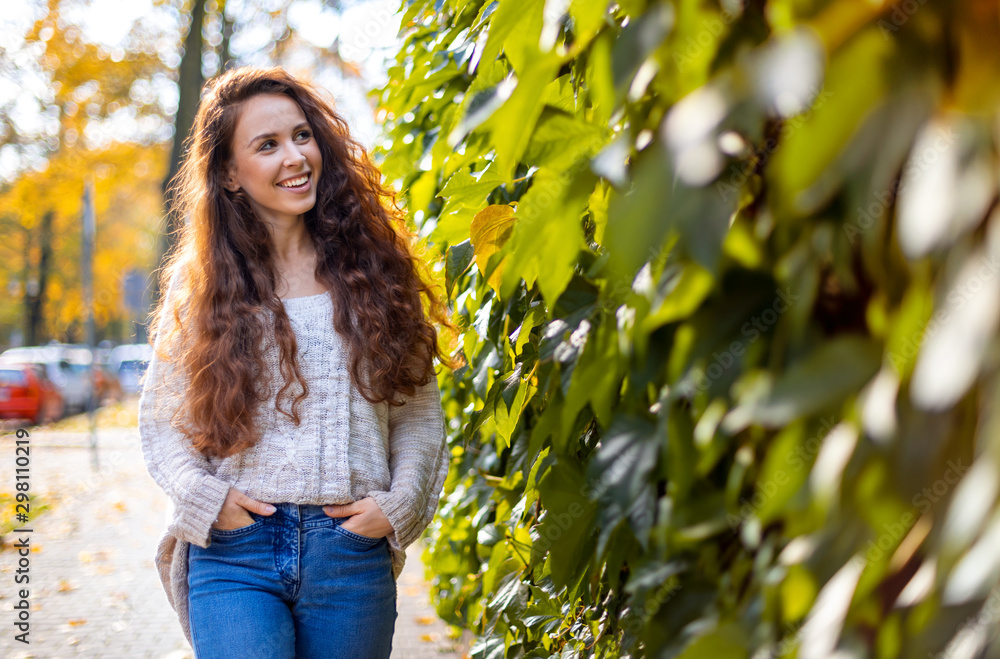 Long haired smiling woman walking on the street outdoors Long haired smiling woman walking on the street outdoors