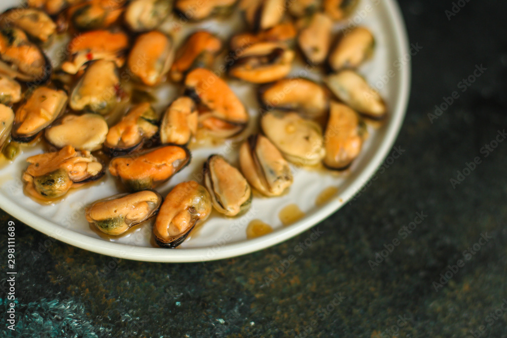 mussels in oil and spices (appetizer mollusks, pickled seafood, healthy food) menu concept. food background. copy space. Top view mussels in oil and spices (appetizer mollusks, pickled seafood, healthy food) menu concept. food background. copy space. Top view