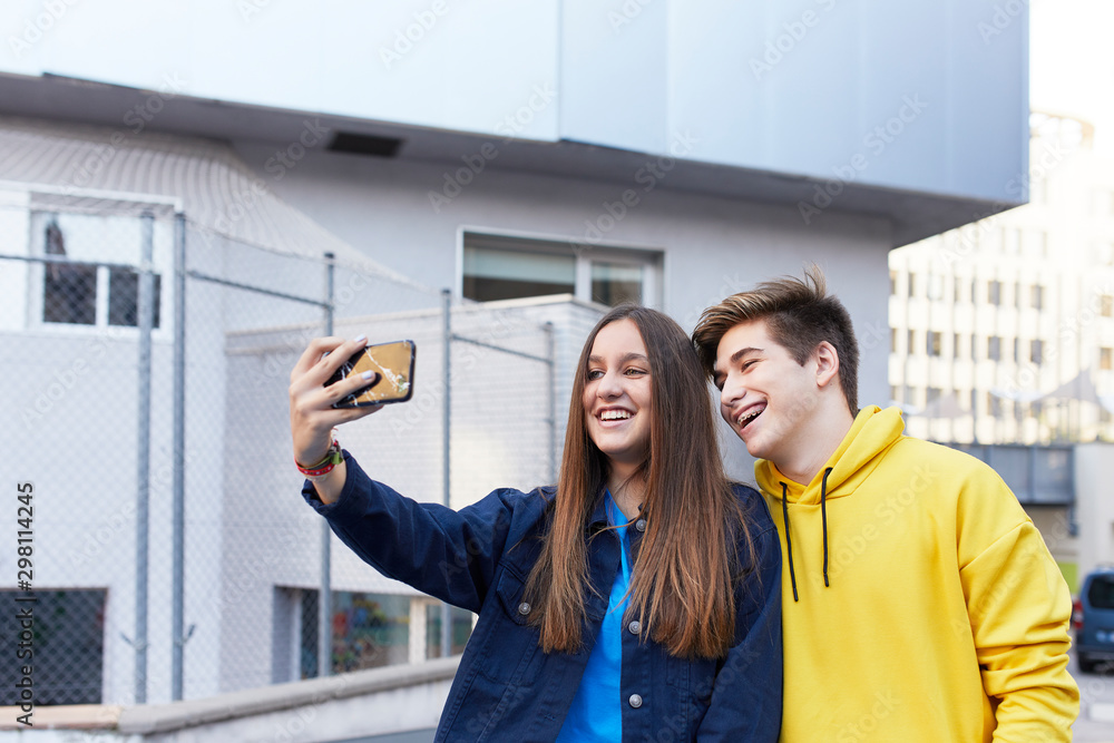 Teenage couple taking a selfie Teenage couple taking a selfie