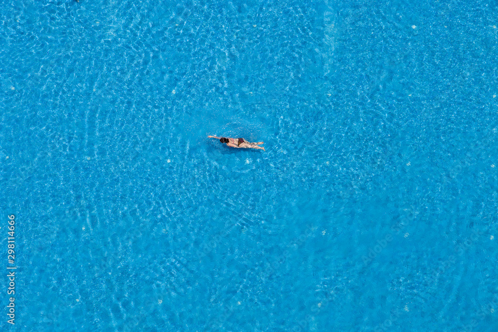 Woman swimming in a pool, top view Woman swimming in a pool, top view