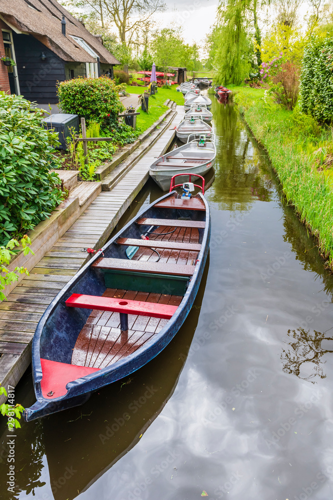 Floating boats, canals and garden in Giethoorn, village of Holl Floating boats, canals and garden in Giethoorn, village of Holl