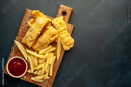 fish and chips with french fries, on a stone background  A