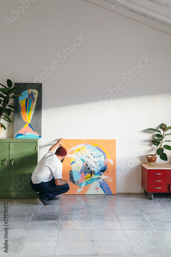 Artist painting in his studio photo