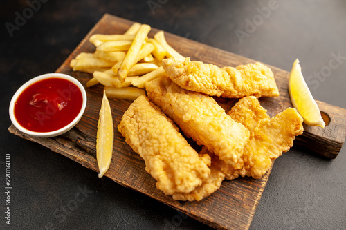 fish and chips with french fries, on a stone background  A photo