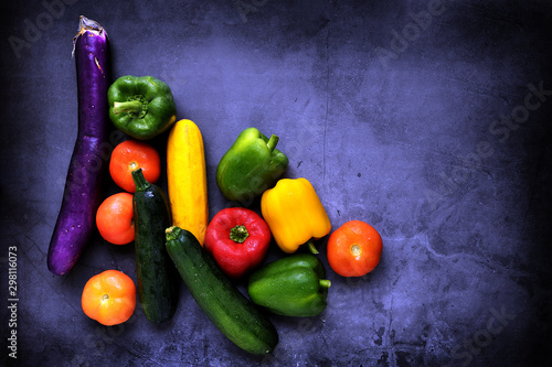 Colorful fresh mixed vegetables over black background with copy space