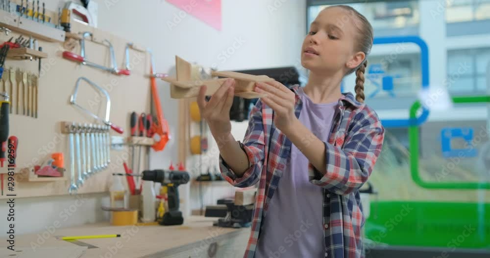 Preteen girl viewing aircraft model in the workshop Stock Video