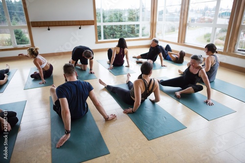 Yoga class sitting on mats in studio. photo