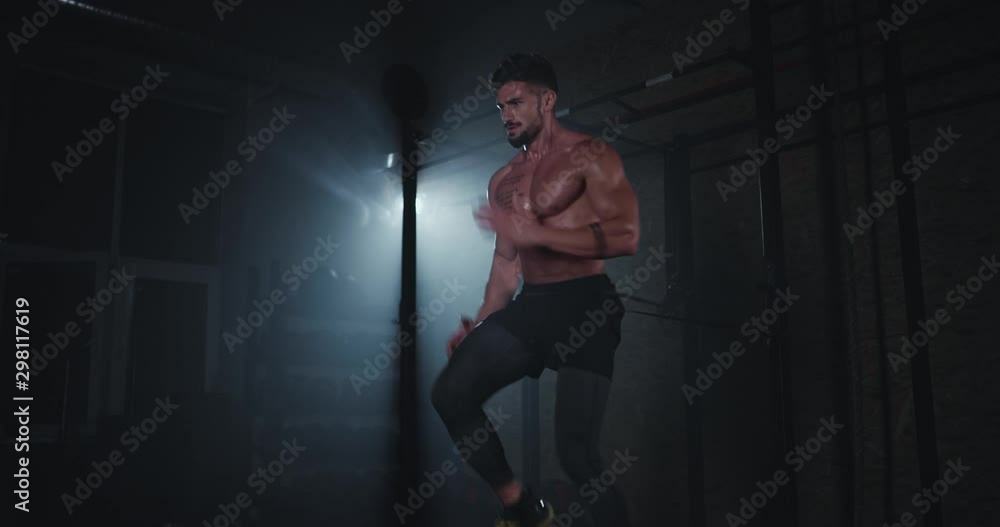 Awesome strong body man with full of muscle and sweating make a very hard cross fit exercises he