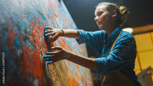Talented Innovative Female Artist Draws with Her Hands on the Large Canvas, Using Fingers She Creates Colorful, Emotional, Sensual Oil Painting. Contemporary Painter Creating Abstract Modern Art photo
