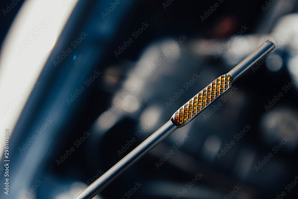 Automotive oil dipstick to check engine oil level. Diagnosis of engine failure. Automotive oil dipstick to check engine oil level. Diagnosis of engine failure.