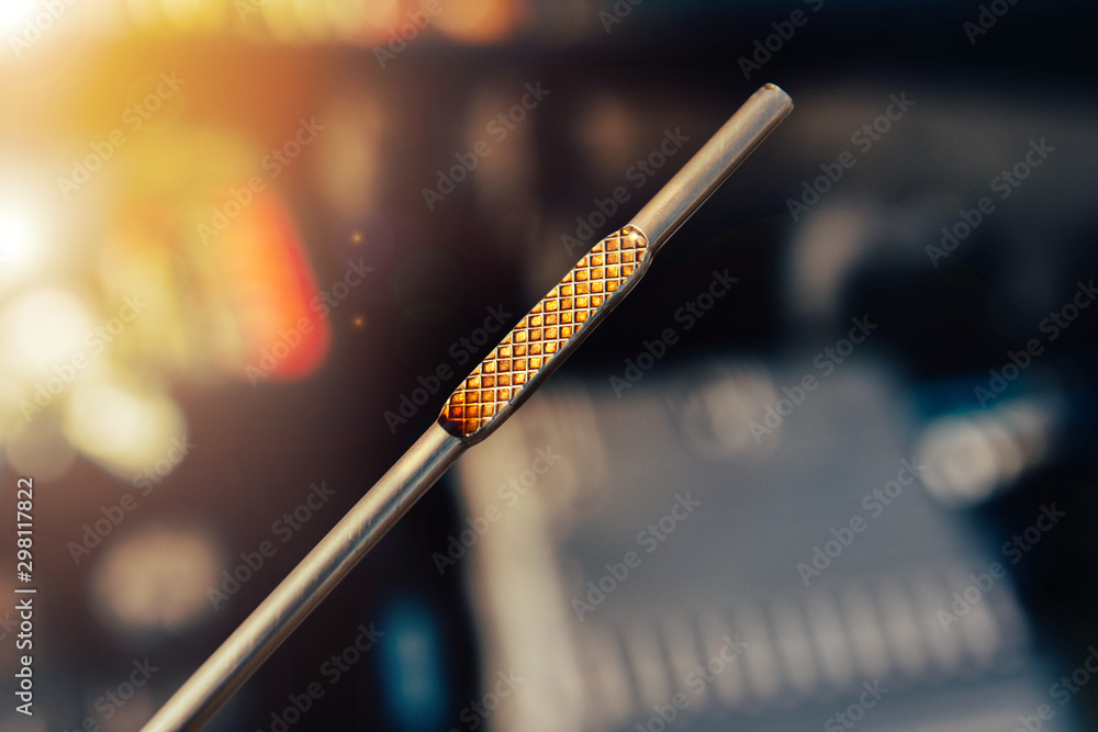 Automotive oil dipstick to check engine oil level. Diagnosis of engine