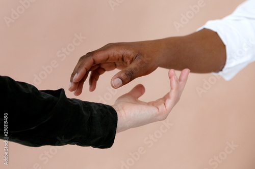 Black and white hands touching each other