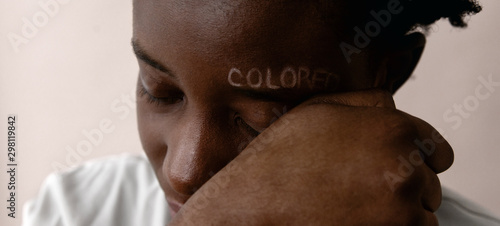 Crop black person rubbing colored writing photo