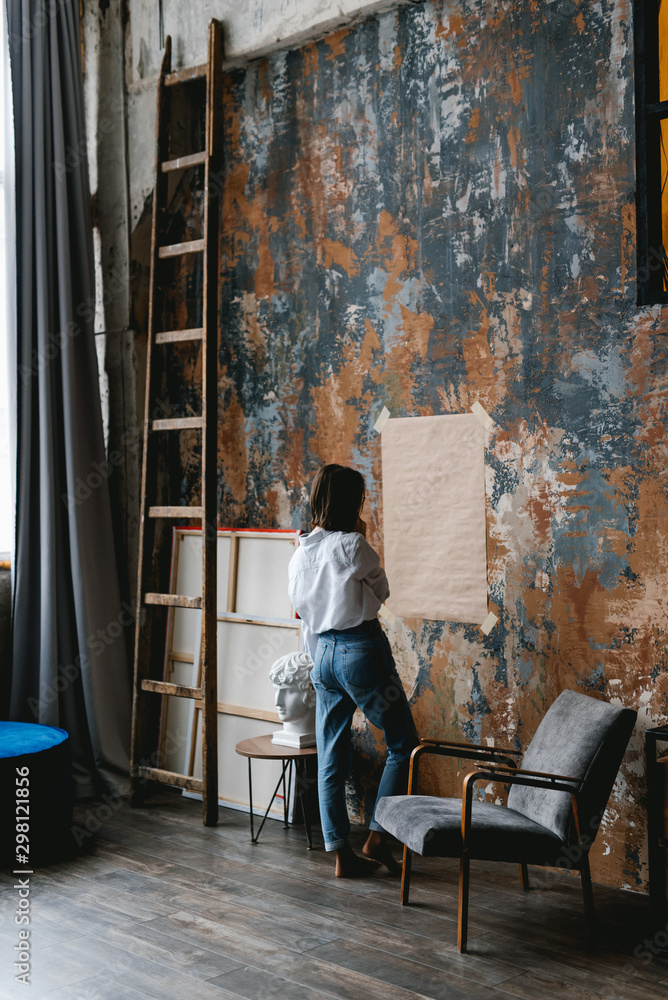 Woman drawing on paper in art studio Woman drawing on paper in art studio