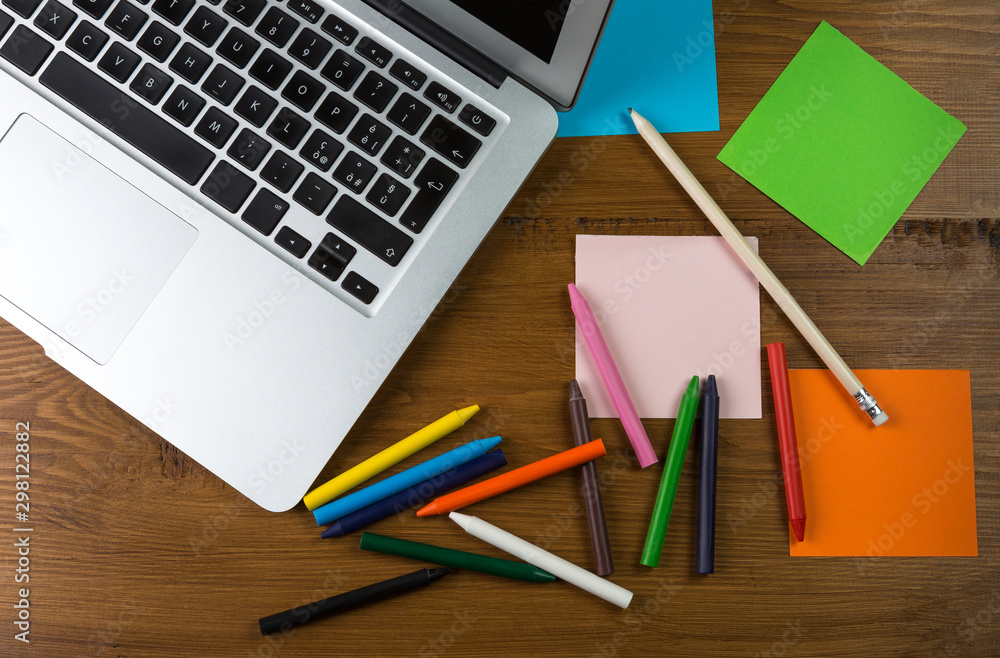 Colored blank post-it with office supplies on wooden table. Colored blank post-it with office supplies on wooden table.