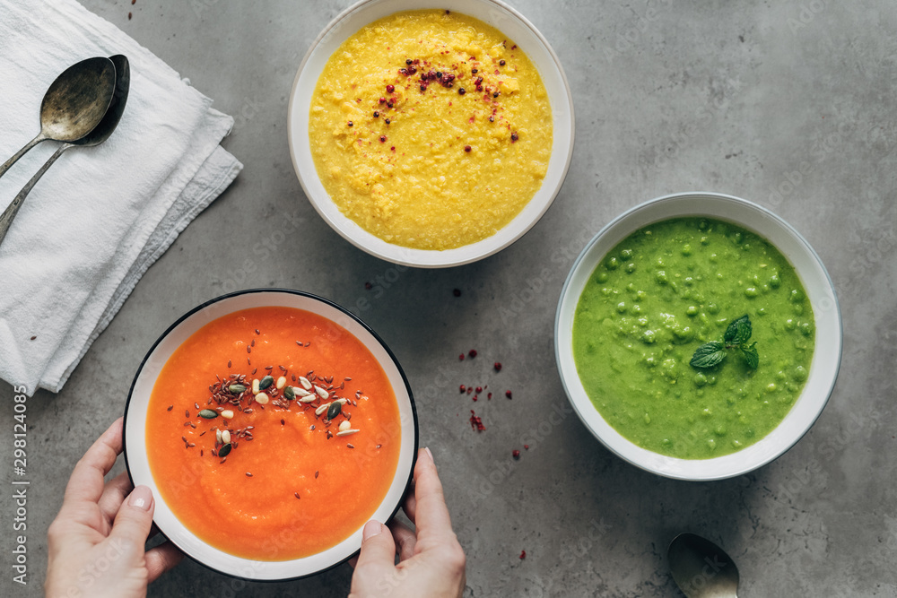 Woman serving gluten-free, low-fat vegetable soups Woman serving gluten-free, low-fat vegetable soups
