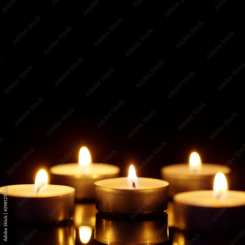 Burning candles with copy space on black background, shot with shallow depth of field Burning candles with copy space on black background, shot with shallow depth of field