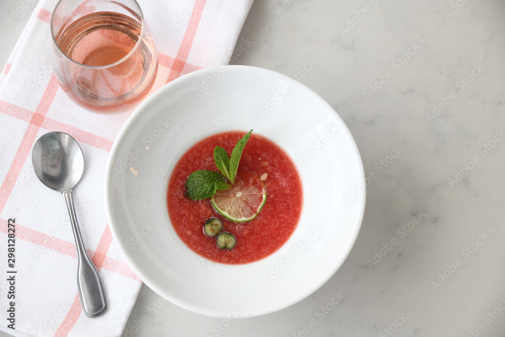 Gazpacho served with drink on table Gazpacho served with drink on table