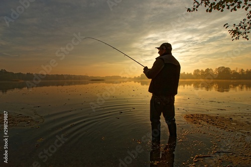 fisherman silhouette during autumnal dawn