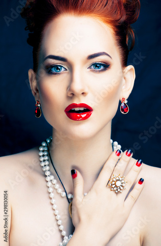 beauty stylish redhead woman with hairstyle and manicure wearing jewelry pearl close up