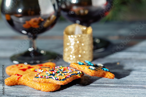 Christmas ginger cookies near the New Year tree on a wooden table.