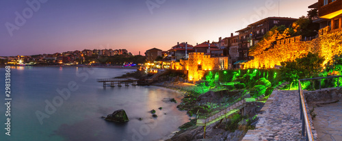 Seaside landscape, panorama, banner - view of the embankment with fortress wall during sunset in the city of Sozopol on the Black Sea coast in Bulgaria