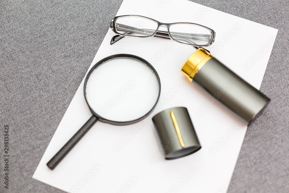 Fototapeta premium Magnifier,glasses and notebook